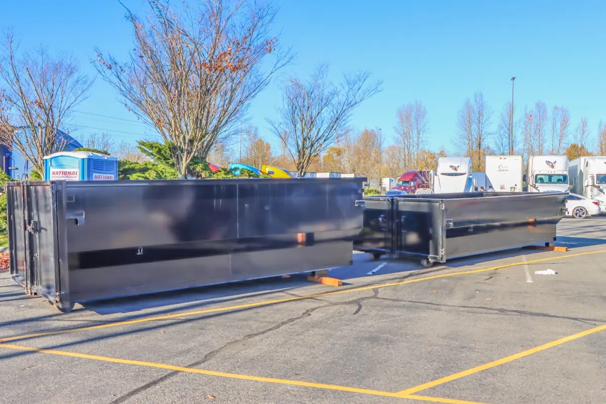 Professional dumpster rental service with roll-off container on residential driveway in Calumet